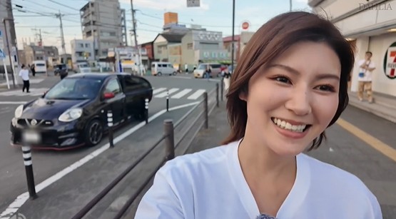 A smiling Japanese escort guide walking through a local area in Osaka, offering foreign tourists a unique way to explore erotic massage and adult services beyond typical soapland venues.